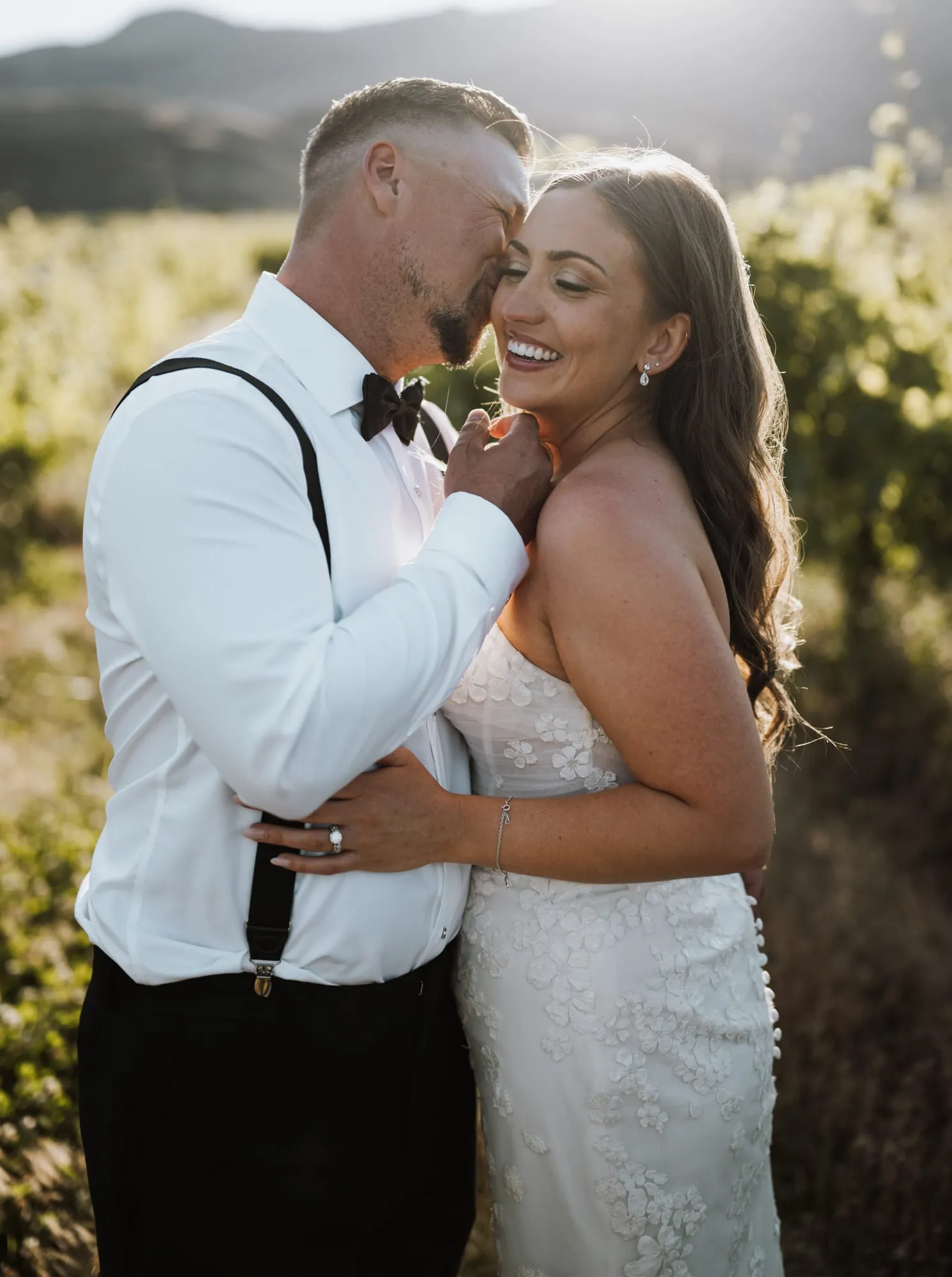 Bride and groom together in a vineyard